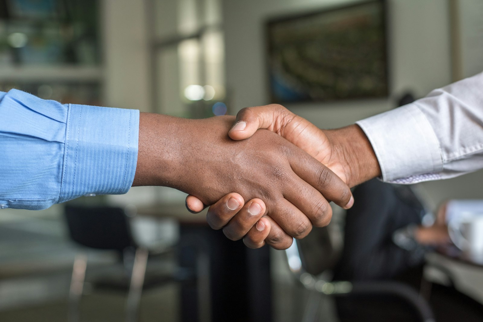 Two people shaking hands after reaching agreement
